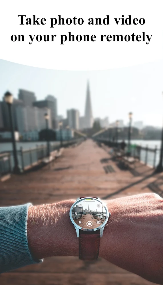 Wear OS watch displaying a live phone camera view of a waterfront